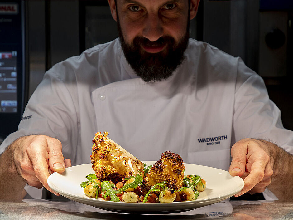 Friendly kitchen team preparing food at The Red Lion - now hiring chefs and kitchen staff